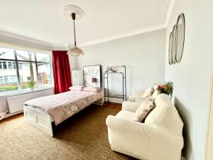 a bedroom with a bed and a couch at Winton house home stay in Bournemouth