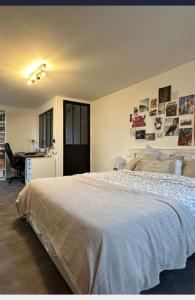 a bedroom with a large white bed and a desk at Maison Bourgeoise Élégante pour 10 Pers Confort Moderne & Charme à Montrichard in Montrichard +11 photos