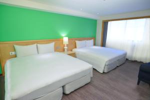 Letto o letti in una camera di Green World Triple Beds