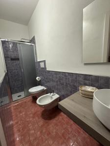 a bathroom with a sink and a toilet and a shower at Sun Home in Vietri sul Mare +6 photos