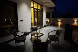 een patio met een tafel en stoelen in een gebouw bij Ranthambhore Bunglow in Sawāi Mādhopur