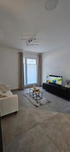 a living room with a couch and a tv at Ludwig 2 in Freudenstadt