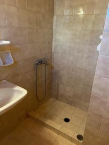 a bathroom with a shower and a sink at Villa Makis Studios in Skiathos Town