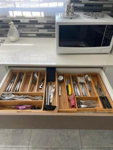 a kitchen counter with a drawer filled with utensils at Giftly Surprize in Kimberley +9 photos