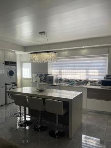 a large kitchen with a large island with bar chairs at Giftly Surprize in Kimberley