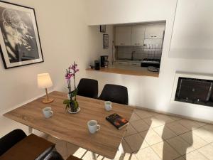 a dining room with a table and a kitchen at Bella Rosa in Ghiffa +12 photos