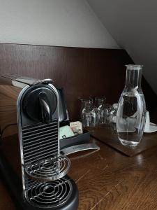 a toaster sitting on top of a wooden table at LONDON Boutique hotel & Restaurant in Trnava