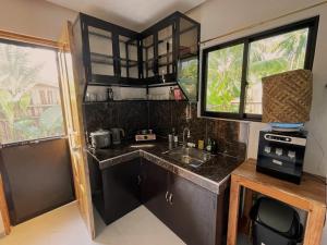 a small kitchen with a sink and a counter at Miraflores - Seaside Villa with private Garden in Siargao in General Luna +26 photos