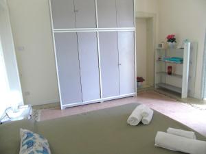 a room with a large white cabinet and towels at Villino Vanzetti 1930 in Cagliari +136 photos