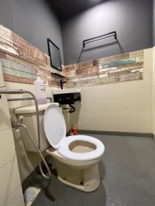 a bathroom with a white toilet in a room at NR Cyber1 Homestay in Cyberjaya +15 photos