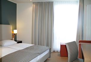 Postel nebo postele na pokoji v ubytování Hotel St.-Michaels-Heim
