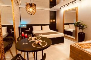 a bedroom with a table and a bed and a mirror at Florence Motel - Santo Ângelo-RS in Santo Ângelo