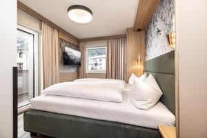 Postel nebo postele na pokoji v ubytování Studio 24 by Hotel Brücke