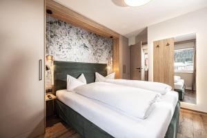 Postel nebo postele na pokoji v ubytování Studio 24 by Hotel Brücke