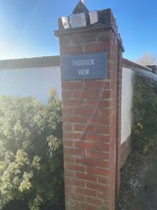 a brick post with a sign for paddock view at Paddock View - Snetterton Norfolk in Norwich