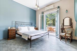 a bedroom with a bed and a table and chairs at Nature Grand Estate in Skopelos Town