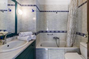 a bathroom with a tub and a sink and a toilet at Nature Grand Estate in Skopelos Town +37 photos