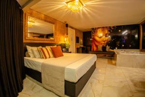 a bedroom with a large bed and a bath tub at Motel Paradiso - Ibirubá-RS in Ibirubá