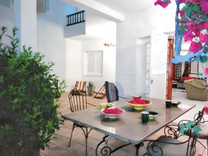 a table with bowls of fruit on it in a room at Elegant villa in Hammamet with year-round private pool in Hammamet