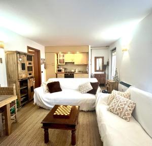 a living room with two beds and a couch at CASA VACANZE OLTRE IL COLLE BBQUEEN in Oltre il Colle