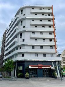 a tall white building with a store in front of it at Paris, la plus belle ville du monde! in Issy-les-Moulineaux +8 photos