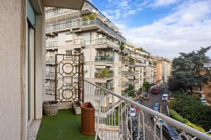 an apartment building with a balcony and a street at Maison G - new design apartment with balcony in Rome