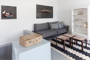 a living room with a couch and a table at Coco-Mat Eco Residences Serifos in Vayiá