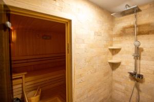 a bathroom with a sauna with a shower backdoor at Къщи за гости ПАВЛЕВСКИ in Banya +45 photos