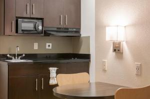 a kitchen with a sink and a microwave at Studio 6-Mcallen, TX in McAllen