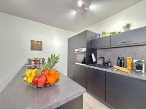 a bowl of fruit on a counter in a kitchen at Auszeit Apartment EMOTION in Friedrichshafen