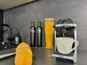 a coffee maker sitting on a counter next to a bread at Auszeit Apartment EMOTION in Friedrichshafen
