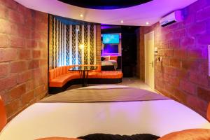 a room with a bed and a bedroom with a couch at Motel Paradiso - Panambi-RS in Tabapira