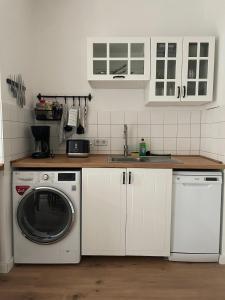 a kitchen with a washing machine and a sink at Apartment in Reudnitz in Leipzig +1 photo