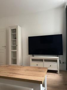 a living room with a flat screen tv on a wall at Apartment in Reudnitz in Leipzig