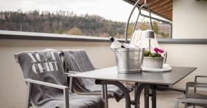 a table with two chairs in a room with a window at Miglurahof in Adnet