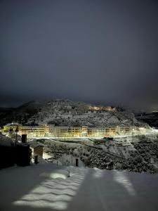 a building on a hill with snow on the ground at Casa Vacanze Donna Erminia in Calitri +66 photos