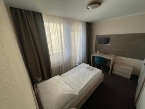 Ein Bett oder Betten in einem Zimmer der Unterkunft Hotel SPECTRUM