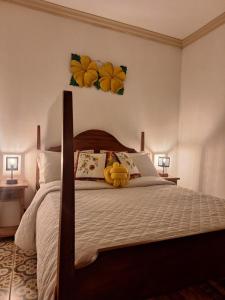 a bedroom with a bed with two flowers on the wall at Pousada Mirante Imperial in Tiradentes