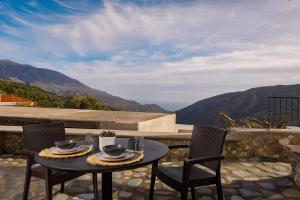 a table and chairs on a patio with a view at Elirion Luxury Home II in Kamária
