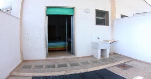 a white building with a sink and a window at Odegos Residence Torre dell'Orso in Torre dell'Orso +130 photos