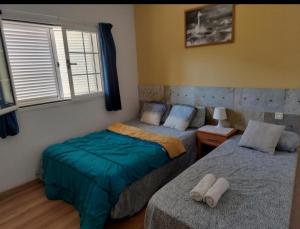 a bedroom with two beds and a window at Gran Canaria Las Palmas Apartment in Mogán +22 photos