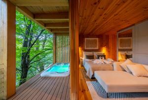 a bedroom in a tree house with a swimming pool at TreeHouses Noszvaj in Noszvaj
