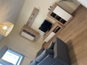 a living room with a couch and a television at Espectacular piso en la playa in Gijón