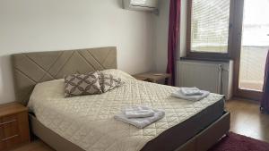 a bedroom with a bed with two towels on it at BT Lux apartment 2 in Skopje