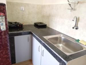 a kitchen with a sink and a counter top at Pilachhen Sinpa 1 Bhk in Pātan