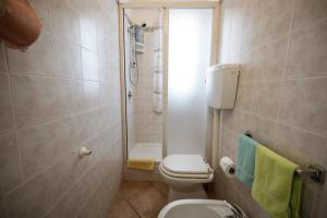 a small bathroom with a toilet and a shower at B&B Panorama in Castelbuono +41 photos
