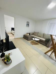 a living room with a couch and a table at Apartmani Star in Tuzla