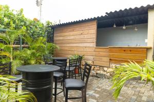 um pátio com mesas e cadeiras num jardim em Nics Appartments - Relaxing vacation 5 min from different beaches em Dorp Sint Michiel
