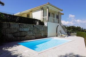 a swimming pool in front of a house at Casa Fundevila Celorico de Basto in Celorico de Basto