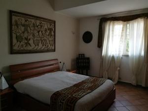 a bedroom with a bed and a window at La Casa dei Daini in Ronciglione
